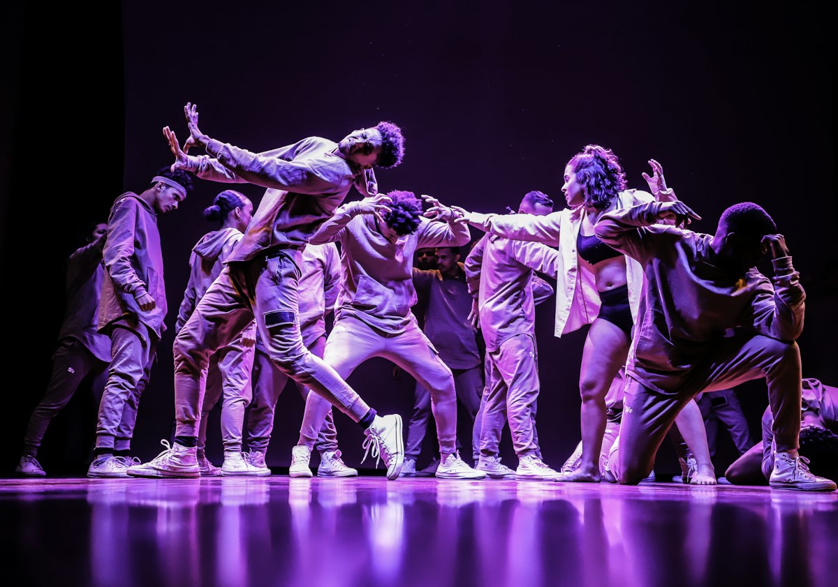 Group of dancers performing an energetic Bollywood-style routine on stage